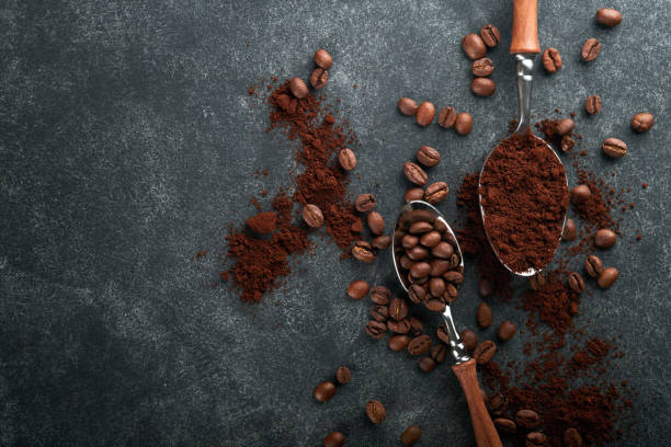 istock Coffee beans background. Roasted Coffee concept with differents types of coffee, beans and cinnamon sticks on dark black stone background. Top view. Coffee concept. Mock up. 1393379405