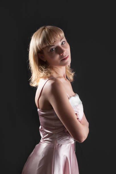 istock blonde in a pink dress 1393380557