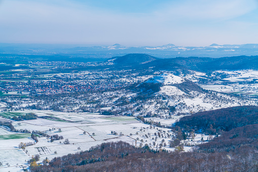 Germany, Aerial panorama view above swabian jura mountains in winter wonderland scene covered with snow around limburg and kirchheim houses