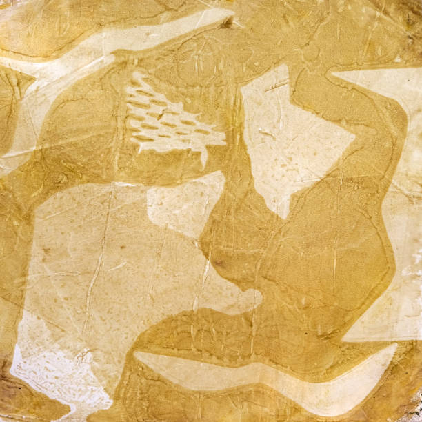 Square abstract acrylic print according to the gelly print method in pastel sand yellow colors, abstract background and organic shapes.