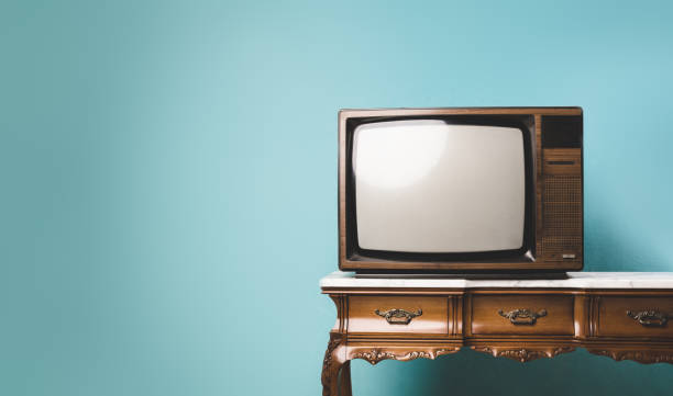 istock Old retro TV on a table over an isolated background. 1393382546