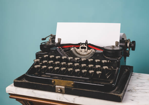 istock View of a vintage typewriter with a blank paper. 1393382551