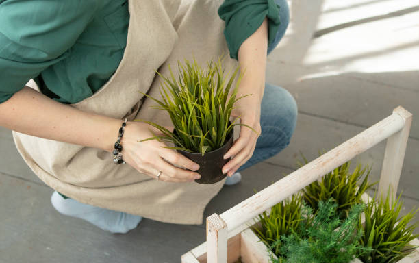 istock girl plants flowers in pots in spring 1393385028