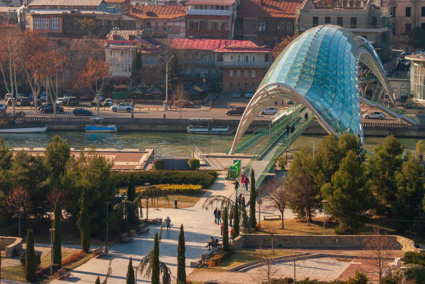 Georgia, Tbilisi - December 31, 2021: People walk on the Peace Bridge in Tbilisi