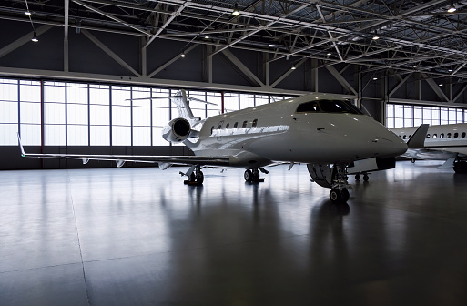 Luxury private jet plane in aviation hangar