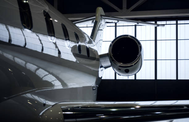 Luxury private jet plane in aviation hangar Luxury business jet airplane being stored inside an aviation hangar. Engine view turbojet engine photos stock pictures, royalty-free photos & images