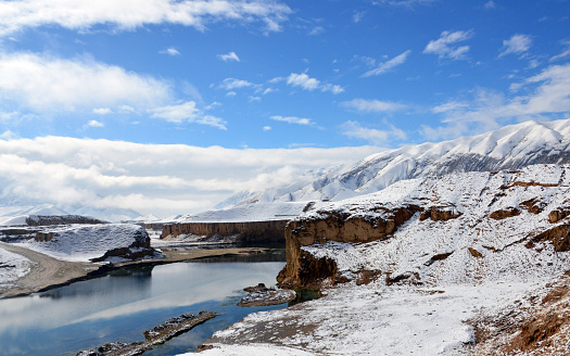 Hazrati Sultan, Samangan Province, Afghanistan: Khulm / Aybak / Tashqurghan river (Darya-i Khulm) and the mountains - beautiful winter landscape. The Khulm is a river of Northern-Central Afghanistan. In its lower course, it passes through Khulm and Haybak. The Khulm is a tributary to the Oxus basin. Its source is located to the South of the city of Khulm. Further upstream, it passes through the city of Samangan and Samangan Province. The Khulm River forms the western border of Kunduz Province.