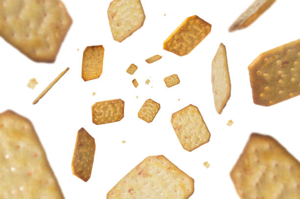 Collection of Crackers falling isolated on white background. Selective focus