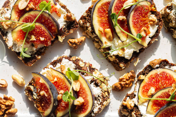 istock Appetizer crostini or bruschetta with fig, cream cheese, honey 1393392342