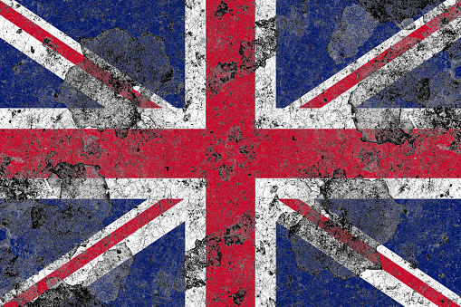 United kingdom flag on a damaged old concrete wall surface