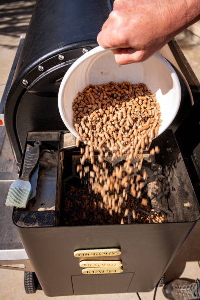 istock Backyard smoker adds pellets for the next project 1393392921
