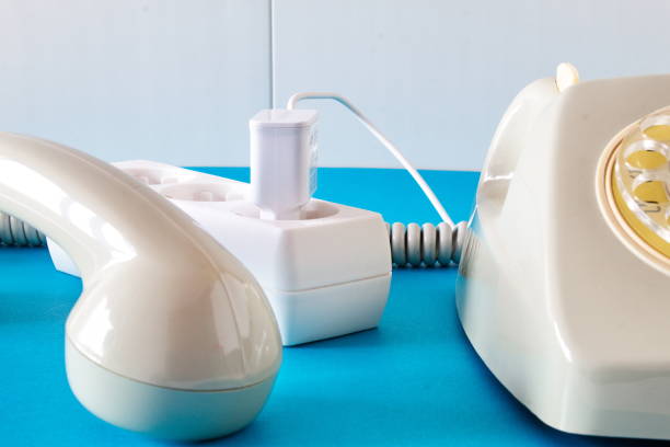istock Old technology telephone connected to the electrical network through a plug 1393393630