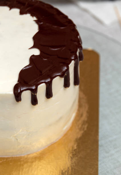 istock Chocolate smudges on the cake with white cream. Close-up. View from above. Selective focus. Images for articles about desserts and confectionery. 1393393657