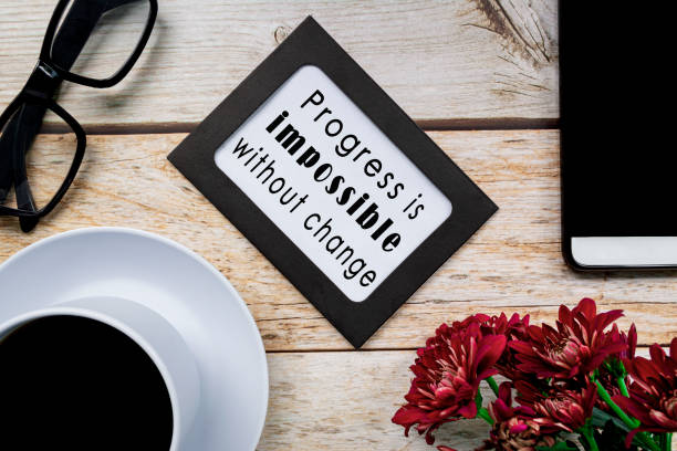 Motivational quote on chalkboard frame on wooden desk. stock photo