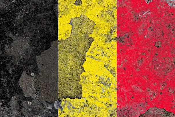 Photo of Belgium flag on a damaged old concrete wall surface