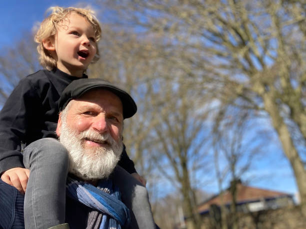 istock Granddad with grandson carrying on shoulder 1393398629