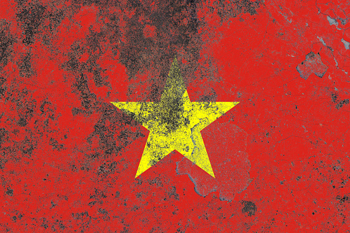 Vietnam flag on a damaged old concrete wall surface