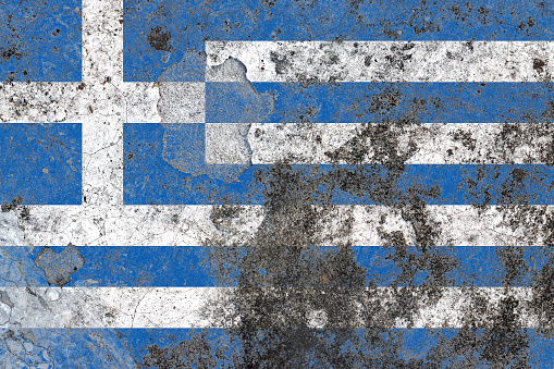Greece flag on a damaged old concrete wall surface
