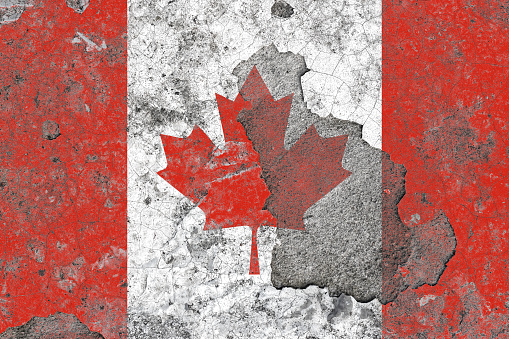 Canada flag on a damaged old concrete wall surface