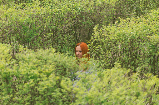Female trying to find way out from a maze hedge