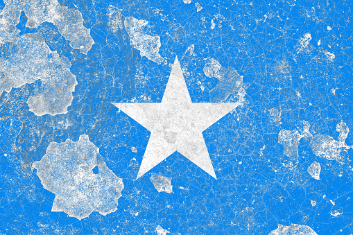 Somalia flag on a damaged old concrete wall surface