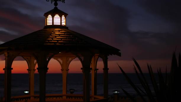 istock Sunset cloudscape, gazebo on beach, twilight dusk, dramatic sky. Alcove and vane 1393400828