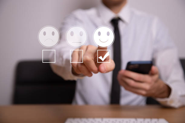 istock Businessman pressing smiley face emoticon on virtual touch screen 1393401045