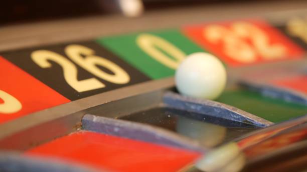 istock Ball on roulette table in casino. Wheel spinning, turning, rotating. Green zero. 1393401291