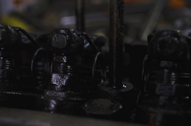 An auto mechanic is working on a car engine in a mechanics garage. Repair service. authentic close-up shot.