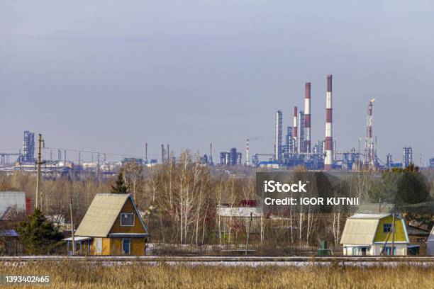 View From A Suburban Village To The Oil Refinery Of A Large Industrial City Stock Photo - Download Image Now