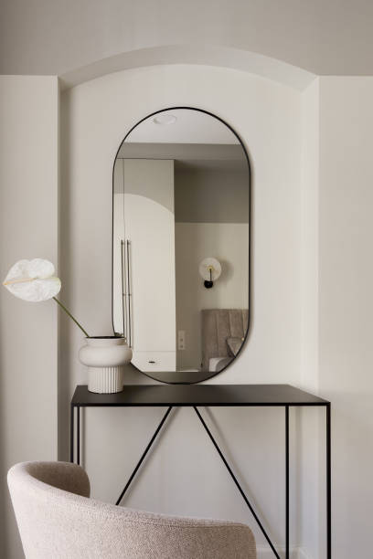istock Single white Anthurium flower in ceramic vase on metal black console table in bedroom interior. Modern interior decoration concept. 1393403327