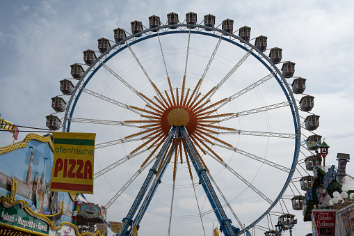 Munich, Germany - April 23, 2022: The Ferris wheel at the Frühlingsfest (Spring Festival) on the Theresienwiese, the first festival since the beginning of the COVID-19 pandemic.