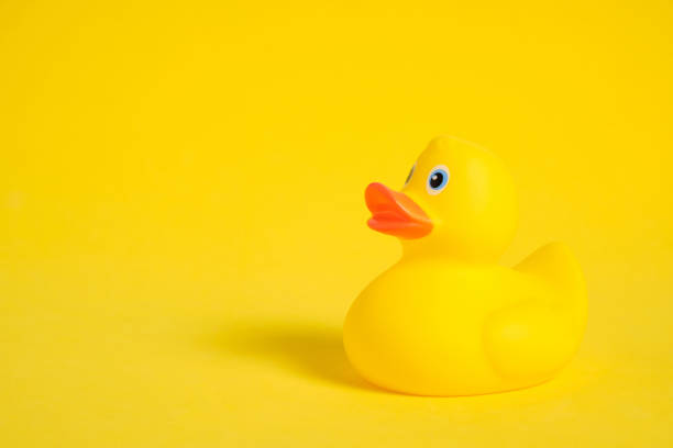istock Yellow rubber duckling on a yellow background. 1393410703