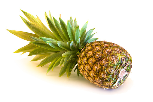 A perfectly ripe pineapple isolated on white background