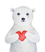 istock Cute little polar bear cub with kind eyes, smiling face and beautiful white fur holding red love heart. 1393416665