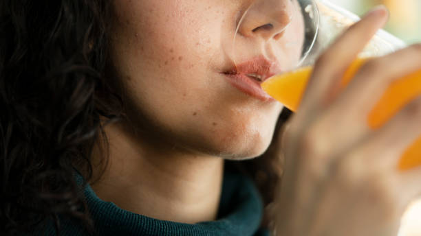 Young woman drinking orange juice