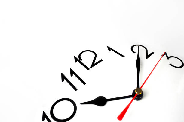 istock Close up clockwise on black clock face background. Wristwatch in retro style, time management or school concept and summer or winter time change 1393419972