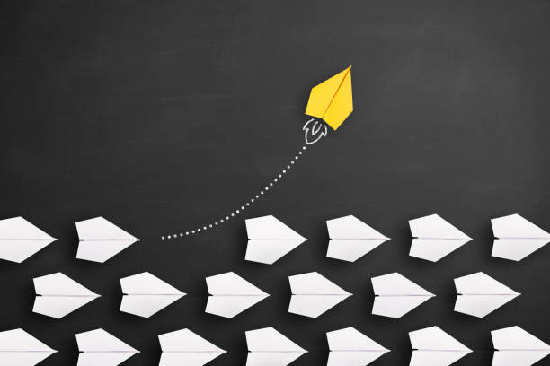 istock Change concepts with yellow paper airplane leading among white 1393420389