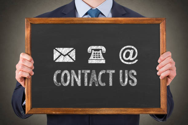 istock Human Hand Drawing Contact Us on Blackboard 1393420446