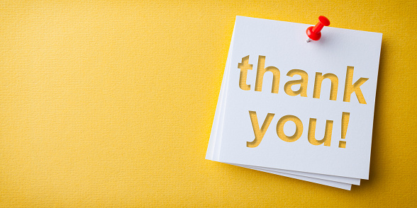 White Sticky Note With Thank You And Red Push Pin Yellow Background