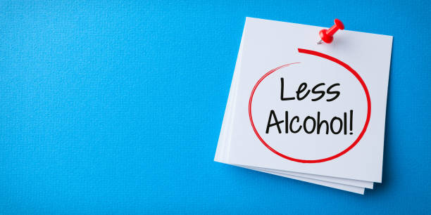 istock White Sticky Note With Less Alcohol And Red Push Pin Blue Background 1393421625