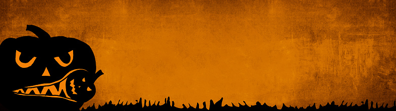 HALLOWEEN background banner wide panoramic panorama template -Silhouette of scary carved luminous cartoon pumpkins isolated on dark orange dusty texture