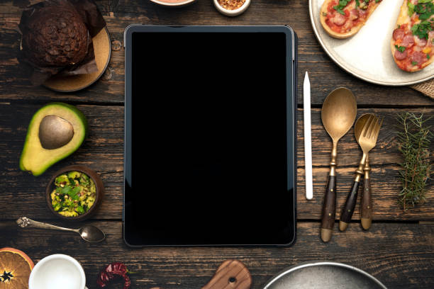 istock Digital tablet computer with mockup white screen on healthy food background. 1393421962