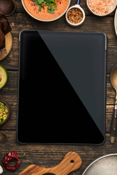 istock Digital tablet computer with mockup white screen on healthy food background. 1393421964