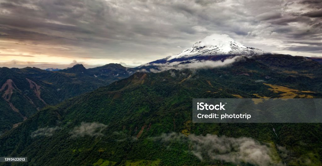 Antisana volcano in Ecuador, view from village Papallacta, snow on the top and green forests around, landscape photography, stratovolcano Antisana volcano in Ecuador, view from village Papallacta, snow on the top and green forests around, landscape photography, stratovolcano. Andes Stock Photo