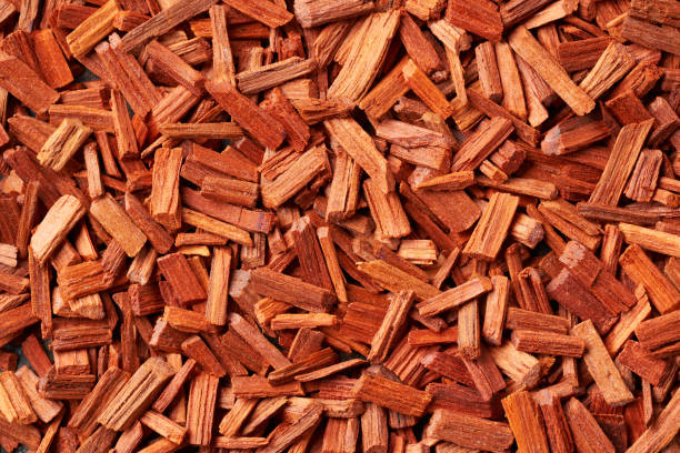 Background made of red sandalwood - copy space Closeup of red sandalwood chips - ingredient for aromatherapy oils massage oil photos stock pictures, royalty-free photos & images