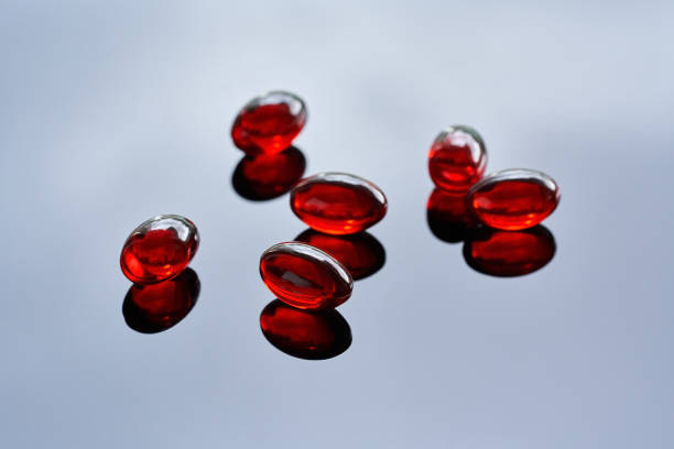 istock Krill oil pills on a glossy background 1393423251