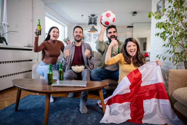 English fans are watching a football  match on TV stock photo