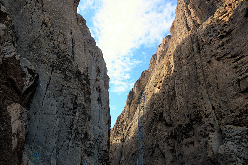 Tangi Tashqurghan gorge, Khulm district, Balkh province, Afghanistan: steep walls of the ravine cut in the mountains by the Khulm river, it carries the main road linking north Afghanistan to Kabul the AH-76 (Asian Highway 76) as well as power lines.