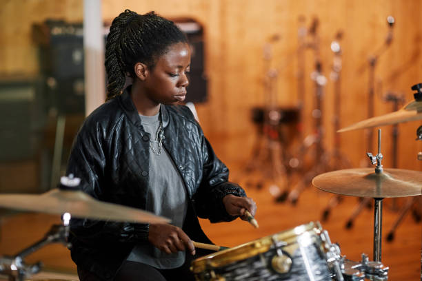 istock Female Drummer at Rehearsal 1393425454